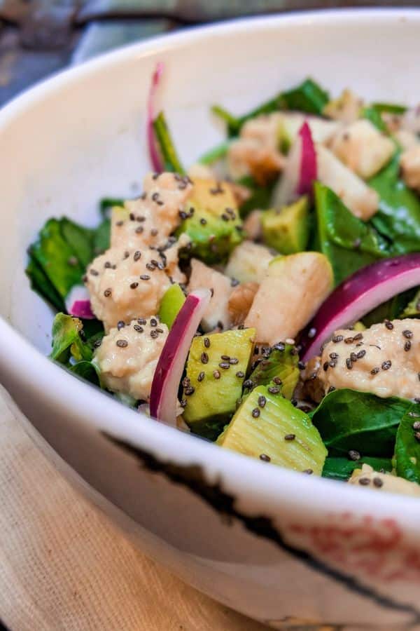 closeup of spinach apple salad